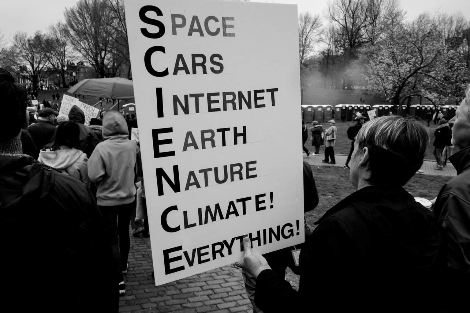 Black and white protest sign about science and climate