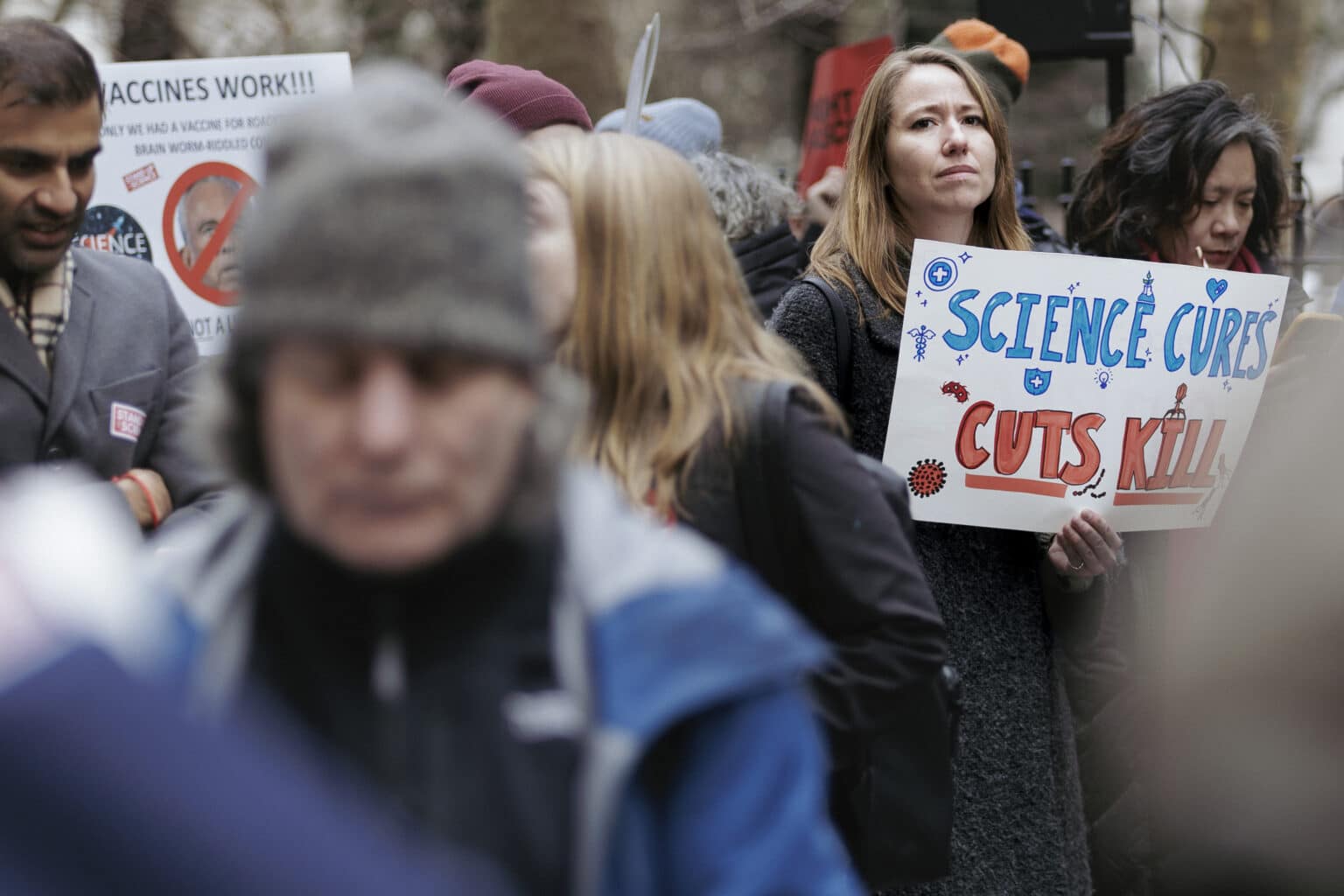 Crowd scene with science-related protest sign