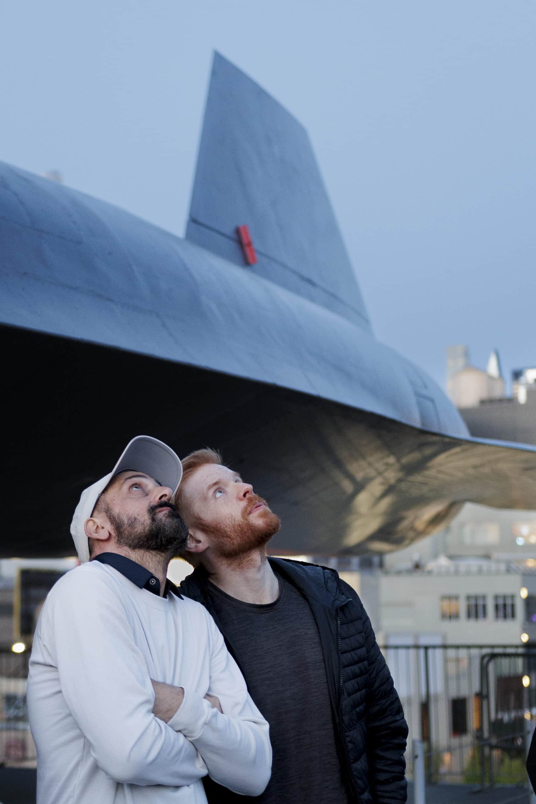 Two visitors look up at the moon on the deck of the Intrepid.