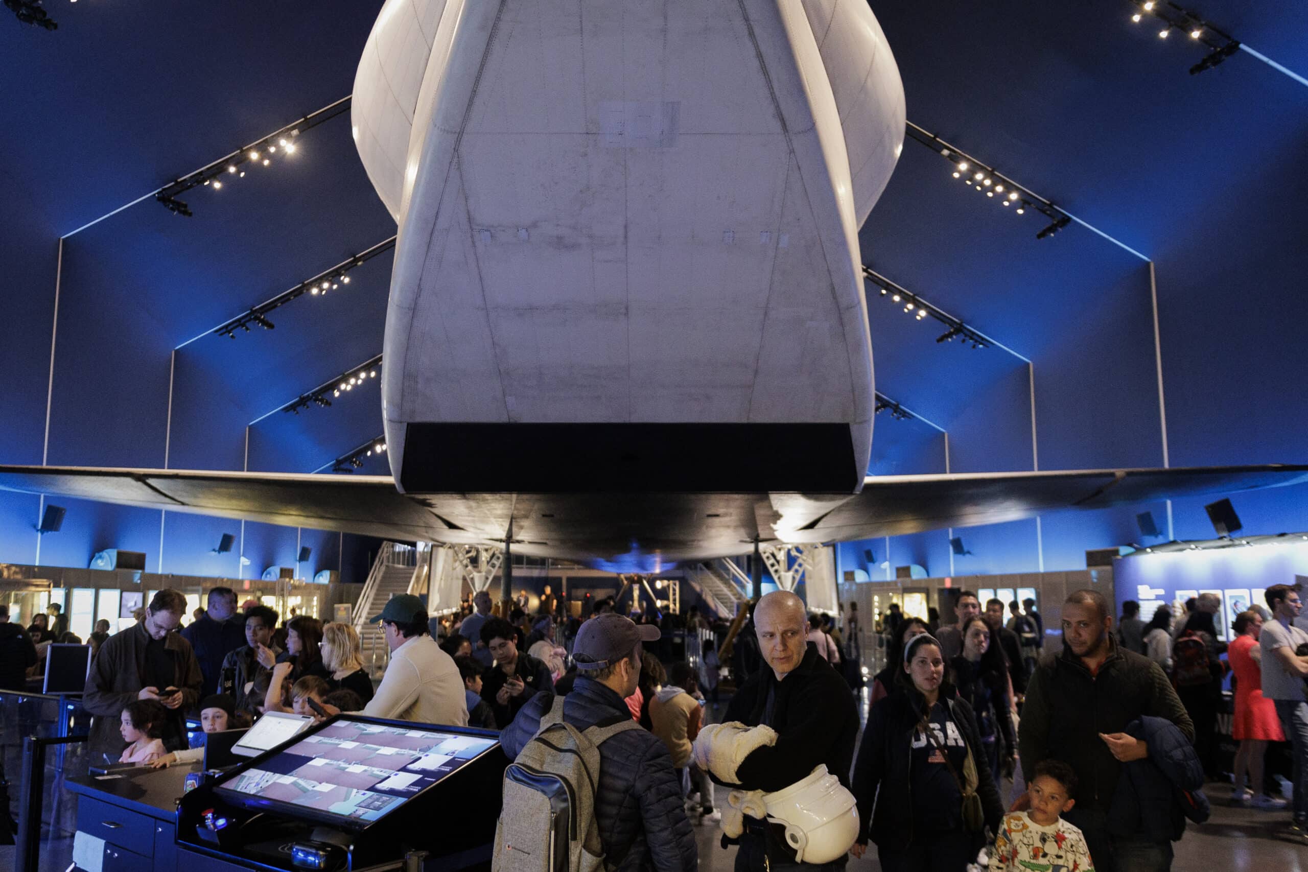 Visitors fill the Intrepid’s Space Shuttle Pavilion beneath the Enterprise shuttle.